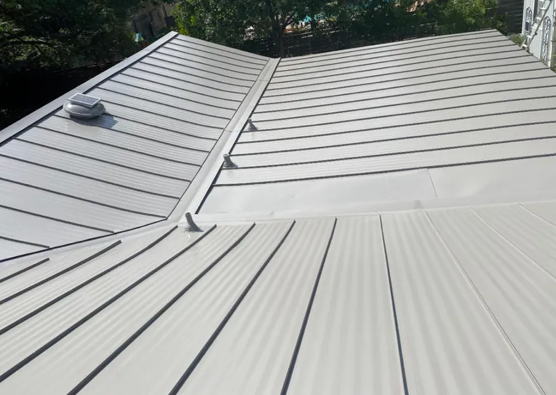 Solar attic fan installed on a metal roof for Roof Ventilation in Palmetto Bay